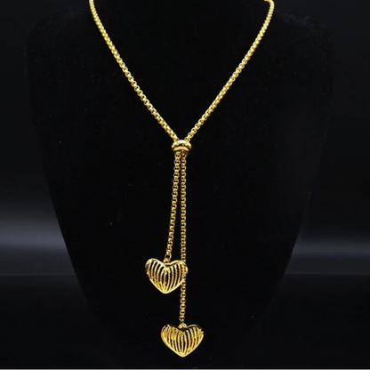 Long gold stainless steel necklace with heart detail.