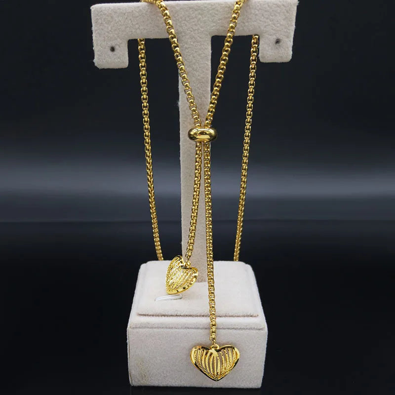 Long gold stainless steel necklace with heart detail.