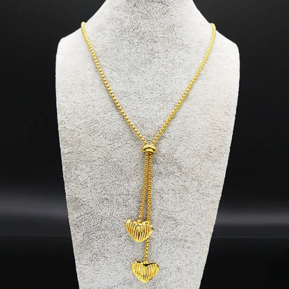 Long gold stainless steel necklace with heart detail.