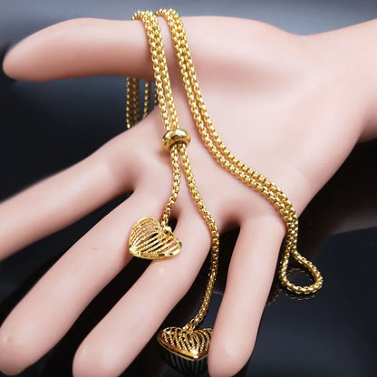 Long gold stainless steel necklace with heart detail.