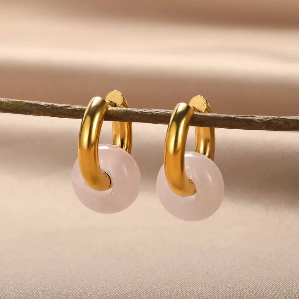 Natural stone dangle earrings. Round gold-colored opal and stainless steel earrings.